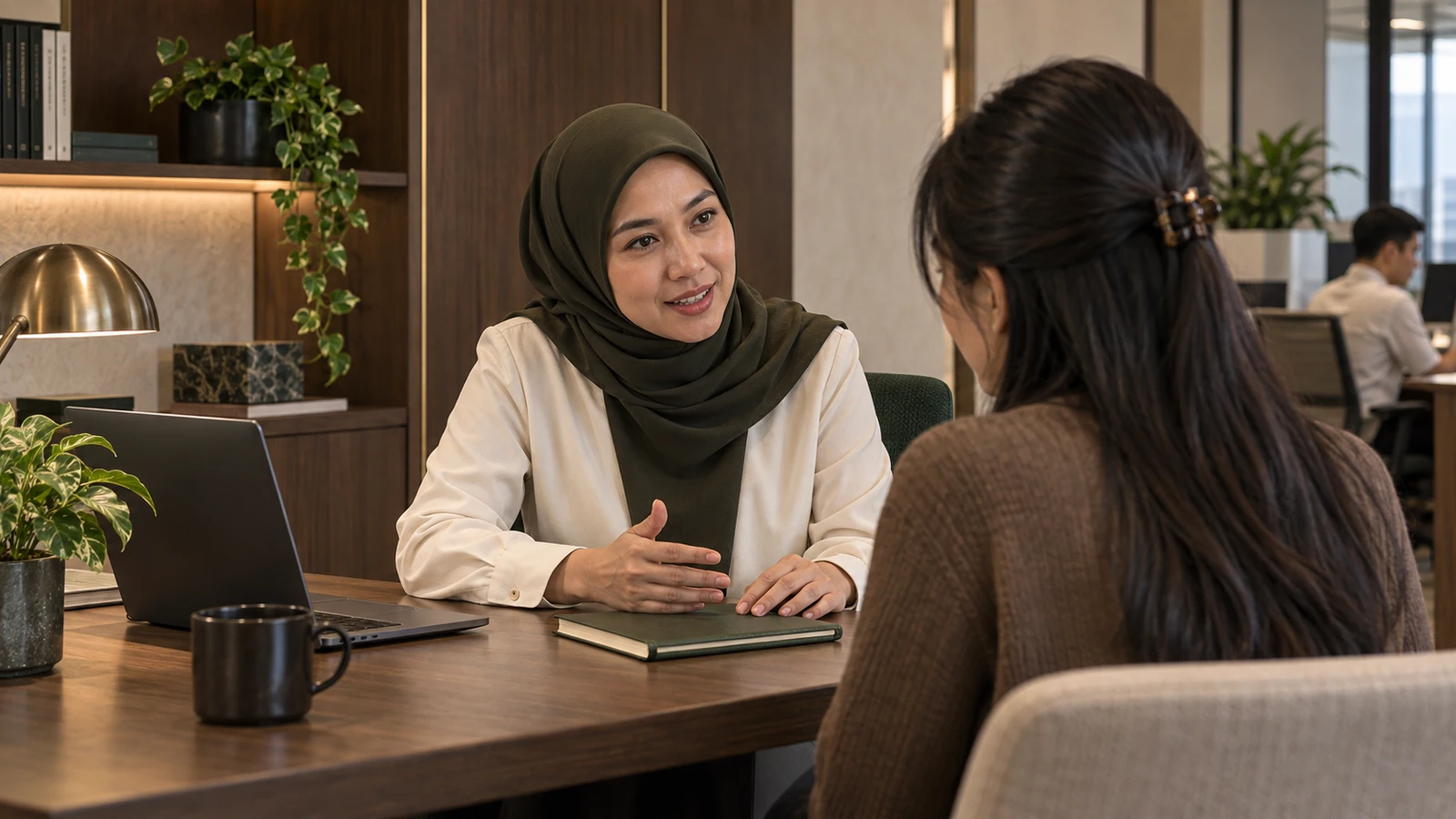 Indonesian mentor and junior colleague discussing a research project