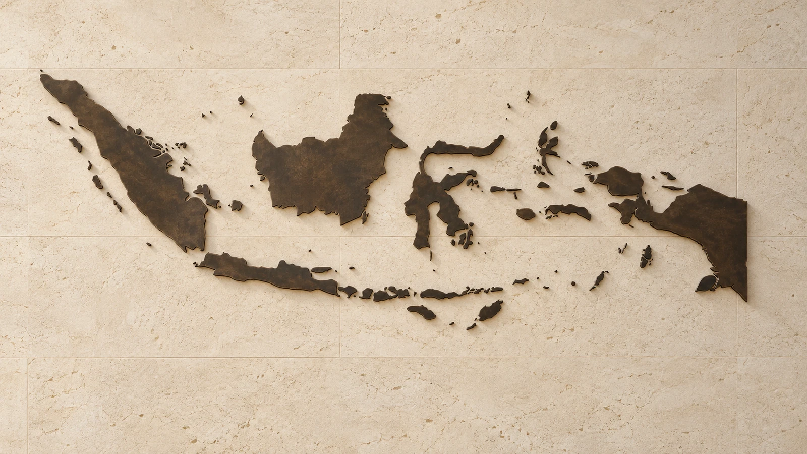 Sculptural map of the Indonesian archipelago in dark bronze on cream stone